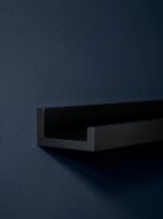 Floating black picture shelf for frames and artwork